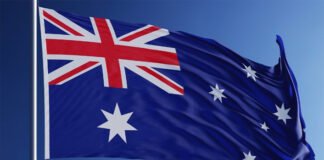 Australia’s Nationals Party Ditches Net Zero Target, Sparks Global Climate Backlash Australian Parliament House under cloudy sky as Nationals Party withdraws from net zero emissions commitment