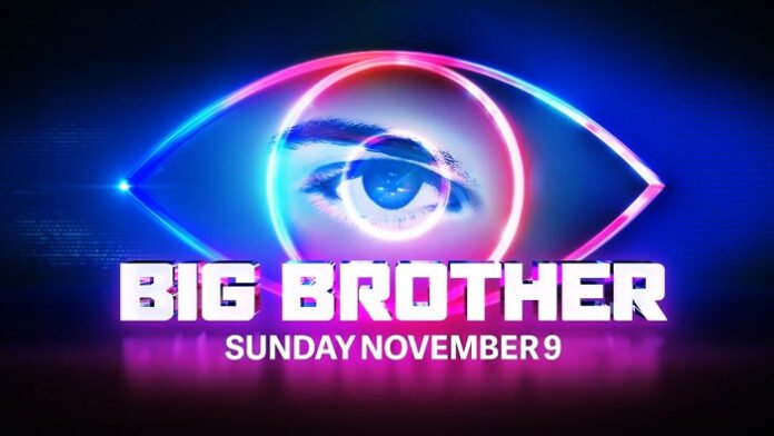 Big Brother Australia 2025 host Mel Tracina on stage with the Big Brother eye logo glowing behind her.”