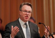 Markets Jump as Fed’s John Williams Signals Possible Near-Term Rate Cut New York Fed President John Williams speaking at an economic policy event.