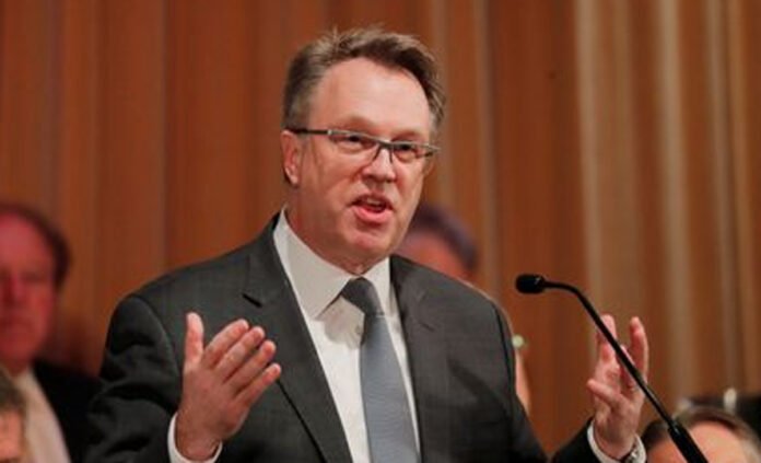 John Williams Signals Possible Fed Rate Cut New York Fed President John Williams speaking at an economic policy event.