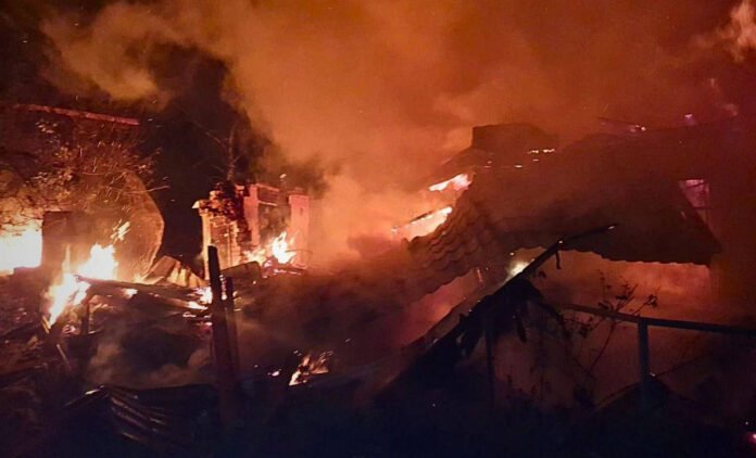 Kyiv skyline shrouded in smoke after Russian missile strikes; civilians seek shelter amid blackouts.