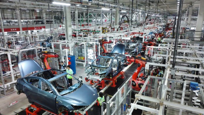 chinese-ev-factory-assembly Modern assembly line in a Chinese electric vehicle factory producing multiple EV models