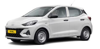 Hyundai Launches Prime Taxi Range With Factory-Fitted CNG in India: Price, Features, Specs Explained Hyundai Prime Taxi range with factory-fitted CNG parked outside a Hyundai dealership in India, showcasing Prime HB hatchback and Prime SD sedan models.