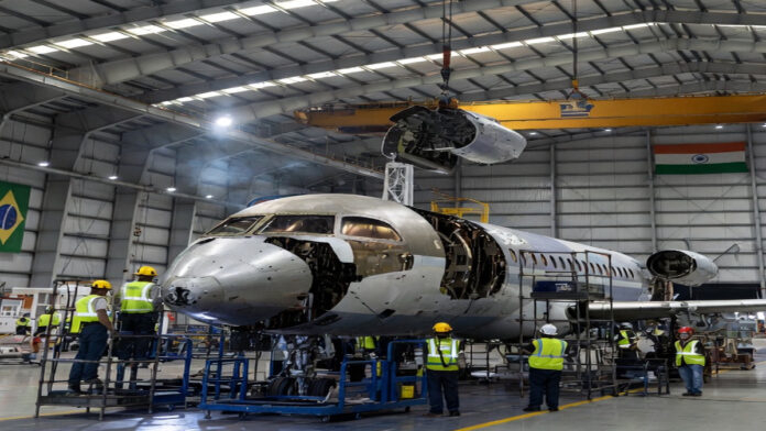 Adani Defence and Embraer executives announcing aircraft manufacturing partnership in India