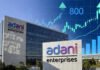 Adani Enterprises’ ₹1,000-Crore NCD Issue Fully Subscribed in 45 Minutes, Signals Strong Investor Confidence Adani Enterprises office building with financial charts symbolizing strong NCD investor demand