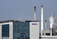 Adani Power Q3 Results: Net Profit Slips to ₹2,488 Crore Despite Stable Operations Adani Power corporate office with power plant infrastructure in the background