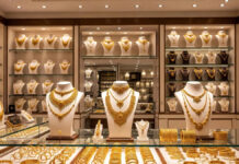Gold Hits ₹1.41 Lakh, Silver Jumps to ₹2.63 Lakh per kg as Global Uncertainty Pushes Prices to New Records Gold and silver bars displayed against rising price charts showing record market highs.