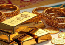 IIFL Finance Q3 FY26 Results: Net Profit Surges Multi-Fold to ₹501 Crore on Gold Loan Boom; Shares Plunge 13% Amid Tax Audit tack of shiny gold bars on office desk with financial charts on monitor, representing gold loan portfolio growth for IIFL Finance Q3 FY26 results