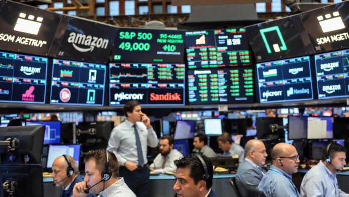 Wall Street stock market trading floor and closing bell with rising index screens