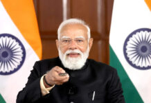 Mahashivratri 2026 Celebrations Sweep India as PM Modi, President Murmu and Leaders Extend Greetings A grand Shiva temple illuminated at night, filled with devotees offering prayers and flowers, capturing the spiritual atmosphere of Mahashivratri.