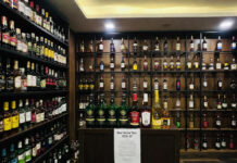 Delhi to Raise Liquor License Fees by 10% From April 1; Alcohol Prices May Increase in 2026–27 Excise Year Liquor bottles displayed at a Delhi store as excise license fees increase by 10% for 2026–27