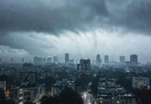 Delhi Weather Takes Sudden Turn: Clouds, Drizzle & 40 km/h Winds as Yellow Alert Issued Dark rain clouds over Delhi skyline during weather alert