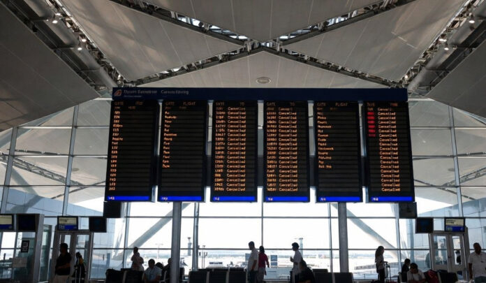 Departure board showing canceled flights at Dubai International Airport amid airspace suspension