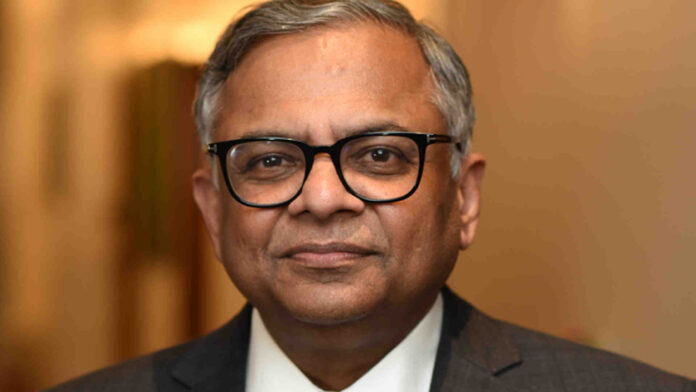 N. Chandrasekaran speaking at a corporate event with Tata Sons headquarters in the background