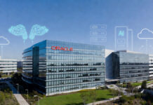 Oracle Considering Up to 30,000 Layoffs to Fund Massive AI Infrastructure Push: Reports Oracle headquarters building in Redwood Shores with modern cloud and AI infrastructure elements in foreground