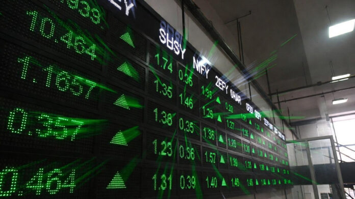Digital display board showing Sensex and Nifty gains inside Bombay Stock Exchange