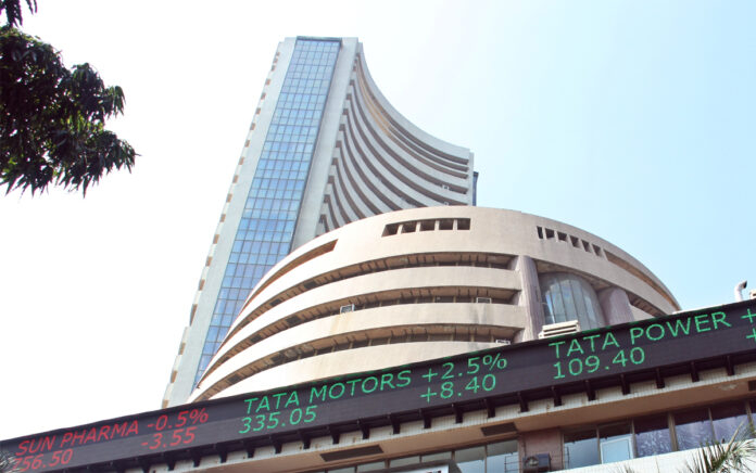 Bombay Stock Exchange building with Sensex ticker showing gains during Thursday trading session