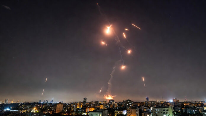 Missile defense system intercepting incoming ballistic missiles over Tel Aviv following US-Israel strikes on Iran