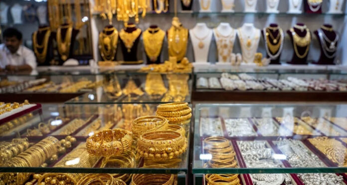 Gold and silver prices decline amid global economic pressures and strong dollar.