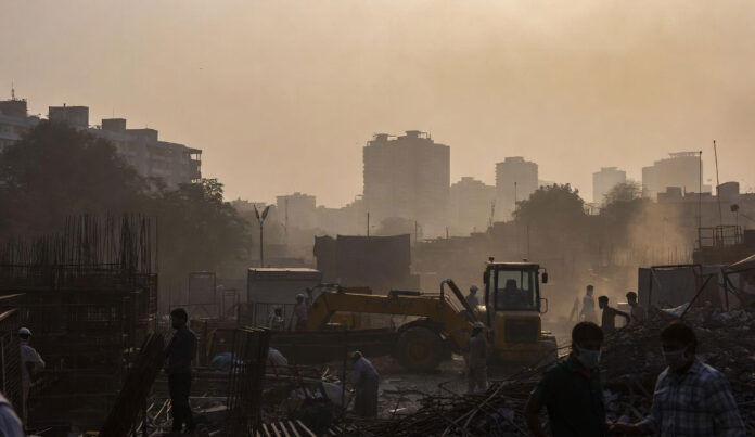 Delhi construction site dust pollution with smog and workers wearing masks