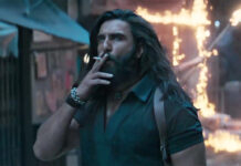 ‘Dhurandhar 2’ Trailer Sparks Buzz Online: Ranveer Singh’s Action-Packed Film Crosses 500K Views Within 3 Hours Ranveer Singh in an intense action scene from the Dhurandhar 2 trailer featuring explosive background visuals