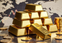 Gold Prices Surge Amid Global Tensions, Near $5,181 in International Market; Local Markets Show Mixed Trend Gold bars and coins representing rising global gold prices amid international tensions