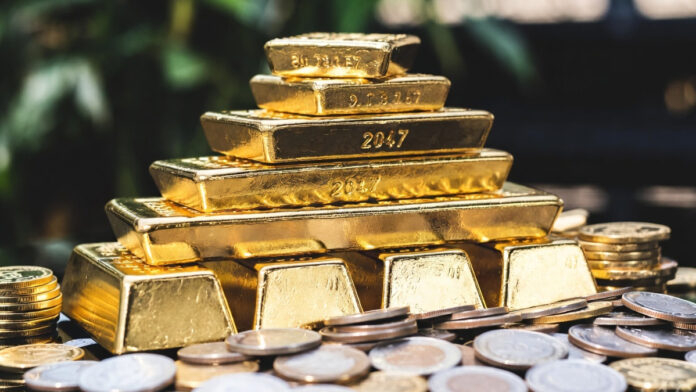 Gold bars and silver coins reflecting surge in precious metal prices amid West Asia tensions