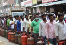 LPG Price Hike Fears Grow in India Amid Middle East Conflict; April 1 Revision in Focus People waiting in line for LPG gas cylinders amid shortage and price hike concerns in India