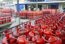 LPG Price Hike: Cooking Gas Gets Costlier Across India as Domestic Cylinder Jumps by ₹60, Commercial Rates Up ₹115 LPG cylinder price hike in India March 2026 domestic cooking gas cylinder and commercial LPG cylinders stacked at distribution center