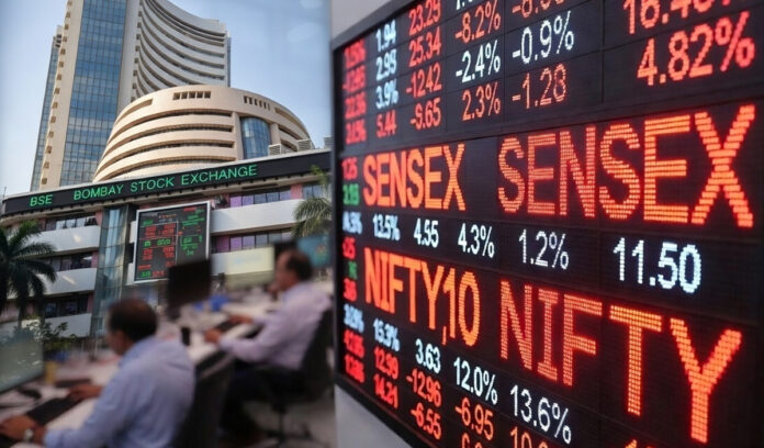 Electronic display board showing Sensex and Nifty falling sharply during a stock market trading session in India.