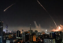 West Asia War Escalates: Oil Surges Toward $100, Stock Markets Reel as Global Trade Faces Fresh Shock Missile trails over a Middle Eastern city skyline during escalating Iran-Israel conflict impacting global oil prices and markets