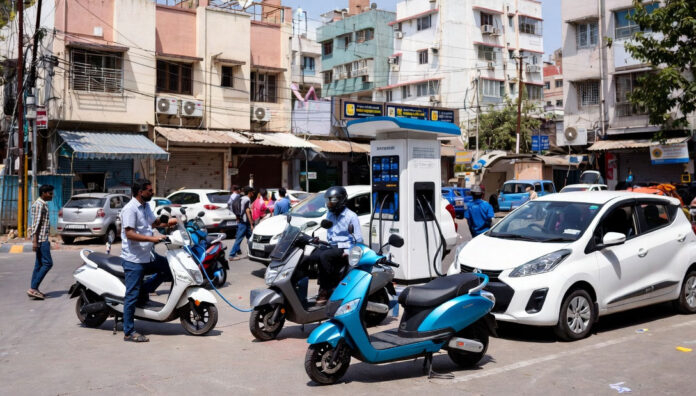 Electric vehicles in India including scooters and cars showing sales growth 2026