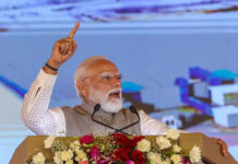 PM Modi Targets Congress, Left in Kerala Rally; Warns Against ‘Provoking Gulf Nations’ Amid Election Heat Narendra Modi addressing a massive election rally in Thiruvalla Kerala with large crowd and BJP flags