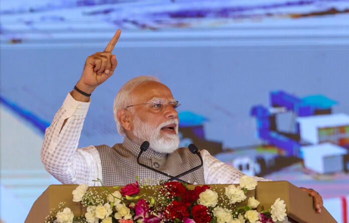 Narendra Modi addressing a massive election rally in Thiruvalla Kerala with large crowd and BJP flags