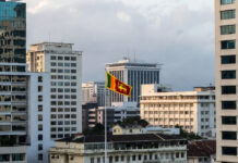 Sri Lanka Reverses Privatization Plan for State-Owned Firms, Informs Supreme Court Colombo skyline with government buildings and Sri Lankan flag representing economic policy decision