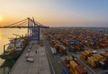 Adani Ports Q4 Results 2026: Profit Jumps 9.4%, Revenue Surges 31% as Cargo Crosses Historic 500 MMT Mark Adani Ports cargo terminal with containers and ships showing strong financial growth in Q4 FY26
