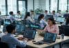 AI Isn’t Killing Jobs: LinkedIn Report Shows 60% Surge in Hiring Across India’s Tech Sector AI professionals working on laptops in modern office showing growth in artificial intelligence jobs in India