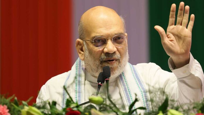 Amit Shah addressing a large BJP rally in Darjeeling with crowd and party flags