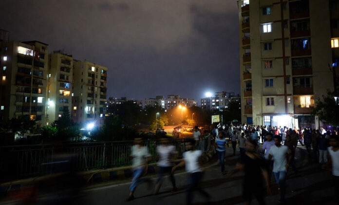 Earthquake tremors in Delhi NCR April 2026 people outside buildings night scene