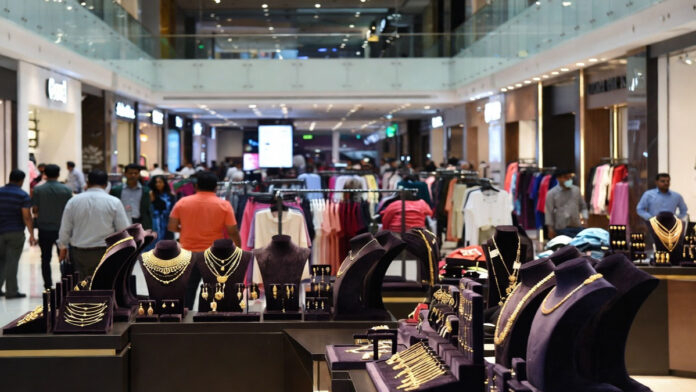 Indian shopping mall with apparel stores and jewelry outlets showing strong consumer demand amid rising costs