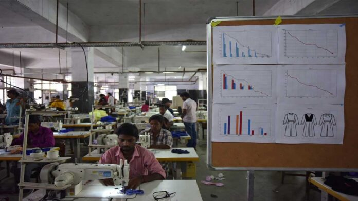 Textile factory workers in India with export decline concept and garments production line