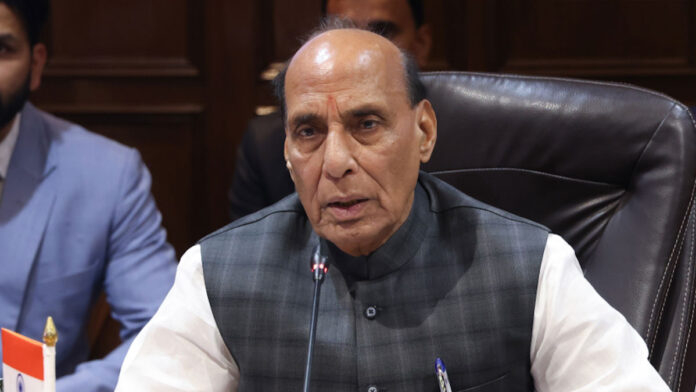 Defense Minister Rajnath Singh addressing an event while discussing India's 7.7 percent GDP growth and economic progress.