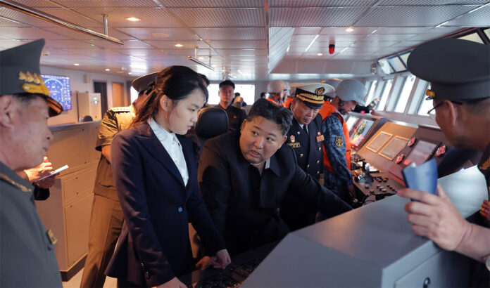 North Korean leader Kim Jong Un inspecting the Kang Kon destroyer during sea trials as military officials accompany him.