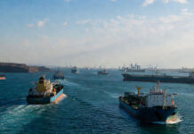Iran Says Strait of Hormuz Will Remain Open but May Face New Transit Charges Amid Regional Tensions Cargo vessels navigating through the Strait of Hormuz as Iran discusses new operational rules for the strategic waterway.